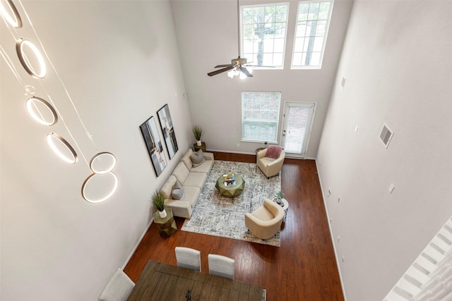 1222 Glenwood Canyon Ln, Houston, TX 77077 - living room with healthy amount of natural light, wood finished floors, a ceiling fan, baseboards, and a high ceiling