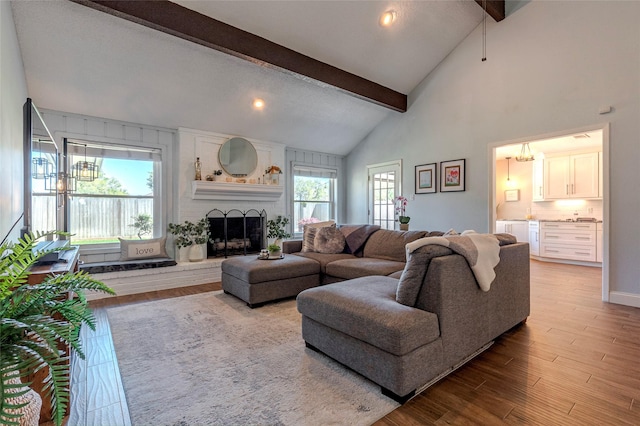 1811 Hunt Dr, Friendswood, TX 77546 - living room with a fireplace, wood finished floors, beam ceiling, and a healthy amount of sunlight