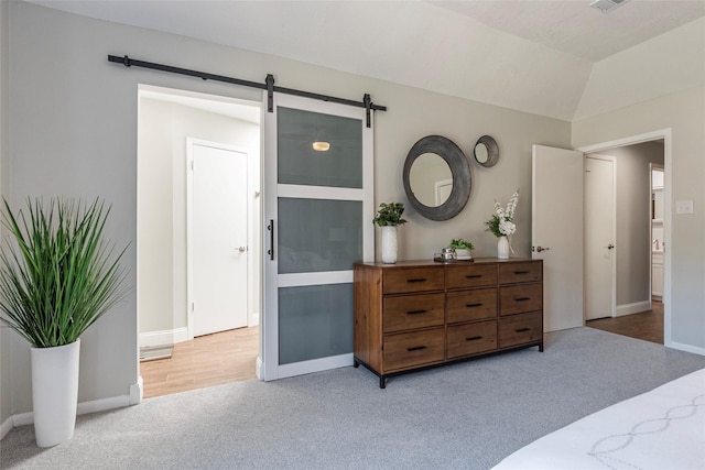 1811 Hunt Dr, Friendswood, TX 77546 - carpeted bedroom featuring baseboards, lofted ceiling, and a barn door