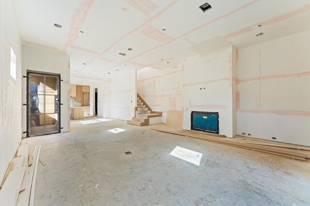 unfurnished living room with stairs