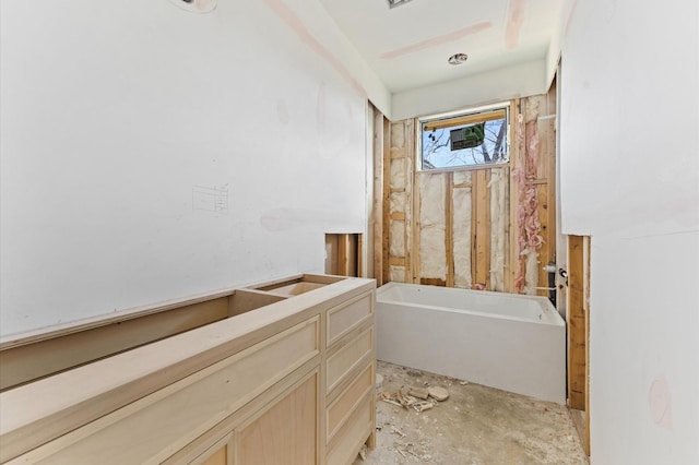 full bath with a tub and unfinished concrete floors