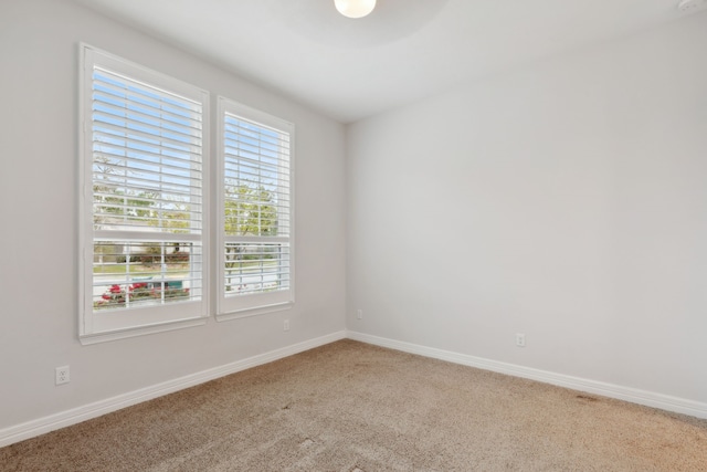 spare room with carpet flooring and baseboards