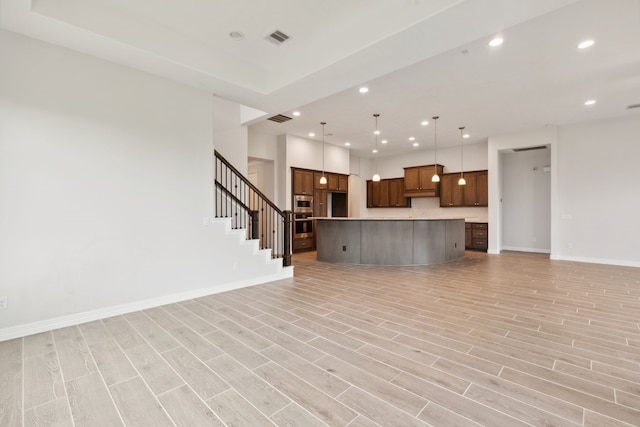 unfurnished living room with light wood finished floors, baseboards, visible vents, and recessed lighting