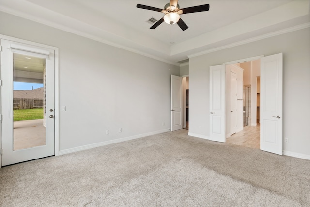 unfurnished bedroom with visible vents, baseboards, a raised ceiling, light carpet, and access to exterior