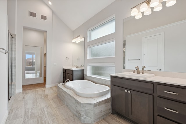 full bathroom with visible vents, a sink, and a garden tub