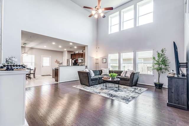 1100 Lasso Ct, Alvin, TX 77511 - living area featuring hardwood / wood-style floors, a high ceiling, baseboards, and ceiling fan