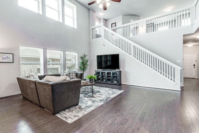 1100 Lasso Ct, Alvin, TX 77511 - living room with stairway, a high ceiling, a ceiling fan, and hardwood / wood-style floors