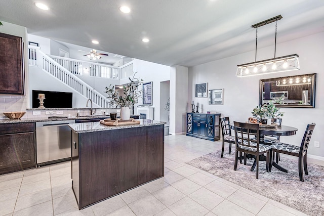 1100 Lasso Ct, Alvin, TX 77511 - kitchen with light stone counters, dark brown cabinets, stainless steel appliances, and a sink