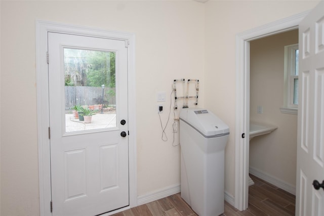 laundry room featuring baseboards, laundry area, and wood finished floors