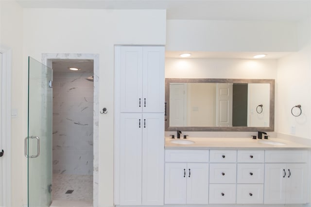full bathroom featuring double vanity, a sink, and a stall shower