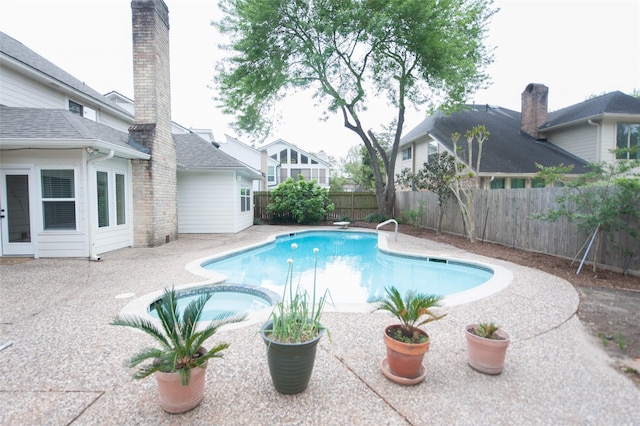 view of swimming pool featuring a fenced backyard, an in ground hot tub, a patio, and a fenced in pool