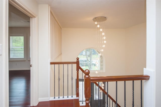 stairs with visible vents, baseboards, and wood finished floors