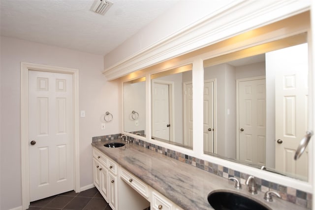 full bathroom with visible vents, a sink, tile patterned flooring, and double vanity