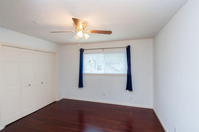 unfurnished bedroom with a closet, baseboards, ceiling fan, and wood finished floors