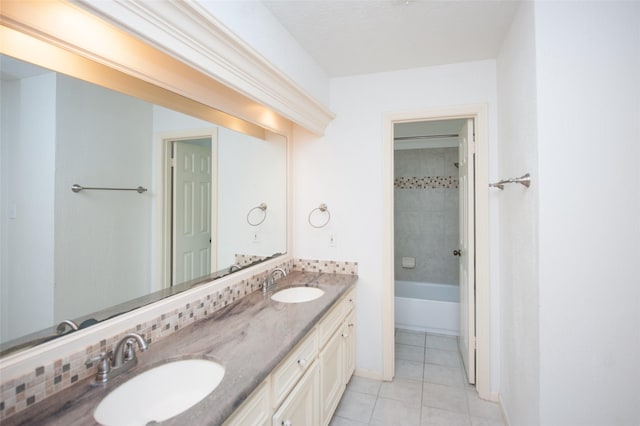 bathroom with double vanity, tile patterned flooring, and a sink