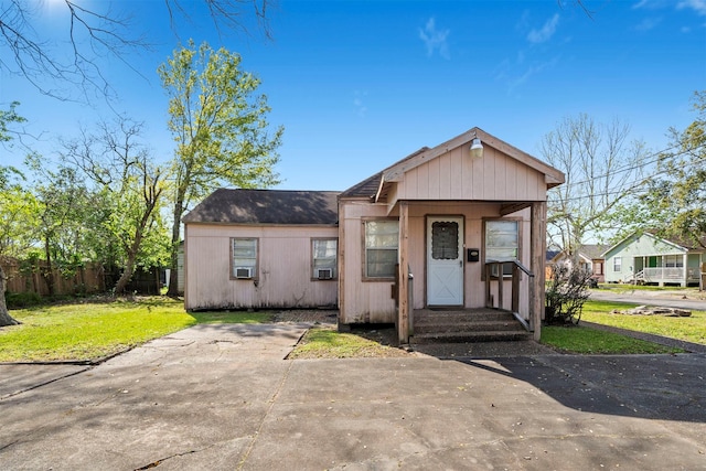 605 Denby St, Baytown, TX 77520 - view of front facade with cooling unit, a front yard, a shingled roof, and fence