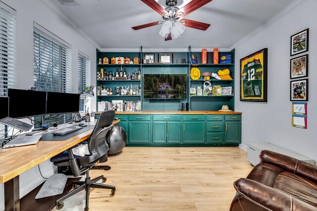 office with a ceiling fan, a baseboard heating unit, light wood-style floors, and crown molding