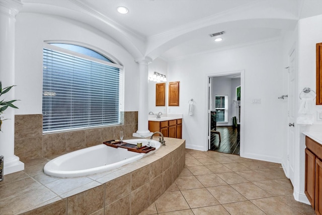 bathroom with visible vents, decorative columns, and two vanities