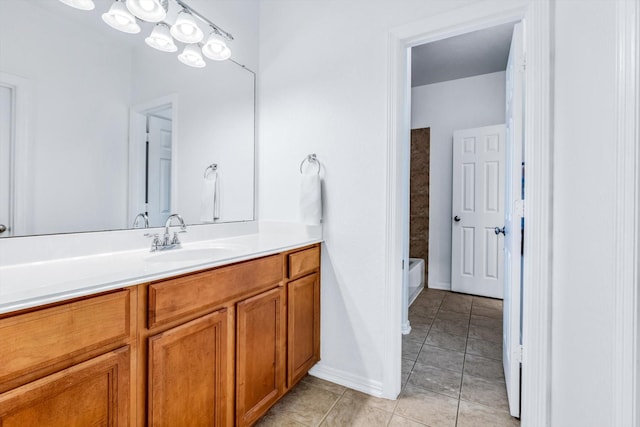 full bath featuring baseboards, a bathing tub, tile patterned flooring, and vanity