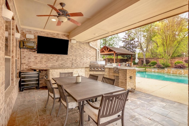 view of patio featuring a fenced backyard, area for grilling, ceiling fan, and outdoor dining space