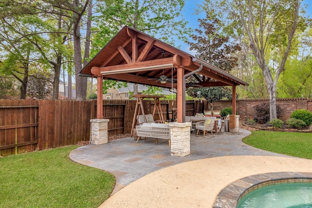 view of patio / terrace with outdoor dining space, ceiling fan, a fenced backyard, and a gazebo