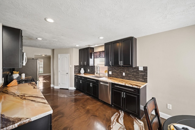 10515 Wind Walker Trl, Houston, TX 77095 - kitchen featuring a sink, backsplash, light countertops, baseboards, and appliances with stainless steel finishes