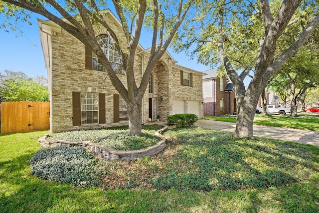 10515 Wind Walker Trl, Houston, TX 77095 - view of front of home featuring an attached garage, fence, concrete driveway, a front lawn, and brick siding