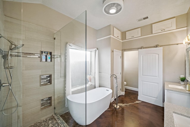 10515 Wind Walker Trl, Houston, TX 77095 - full bathroom with toilet, vanity, visible vents, a freestanding bath, and a tile shower