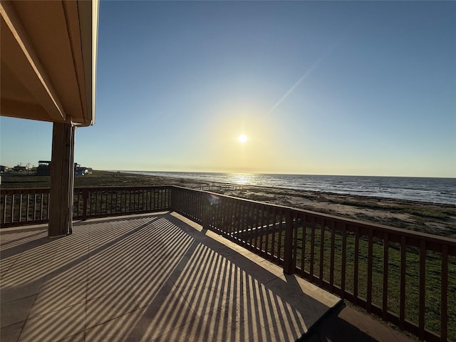 balcony featuring a water view and a beach view