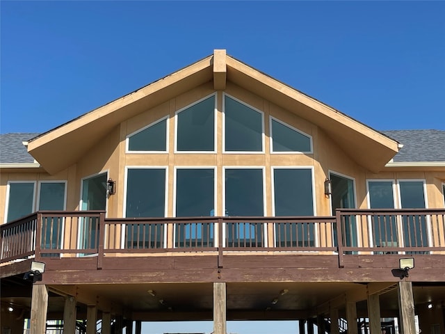 view of home's exterior featuring stucco siding and a shingled roof