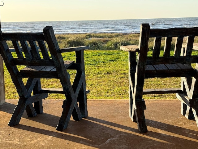 view of gate with a water view and a view of the beach