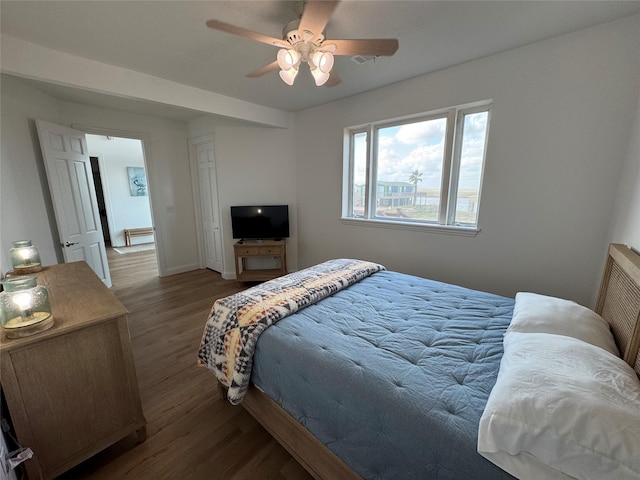 bedroom with visible vents, baseboards, ceiling fan, and wood finished floors