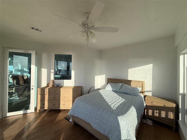 bedroom featuring visible vents, wood finished floors, and a ceiling fan