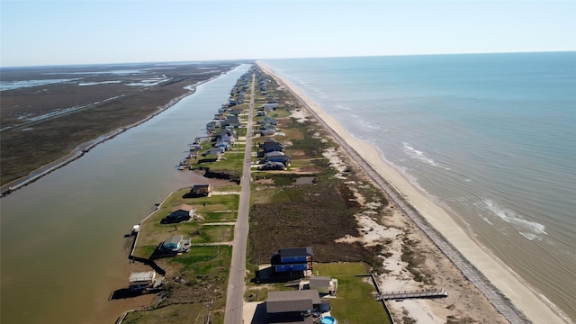 bird's eye view featuring a water view and a beach view