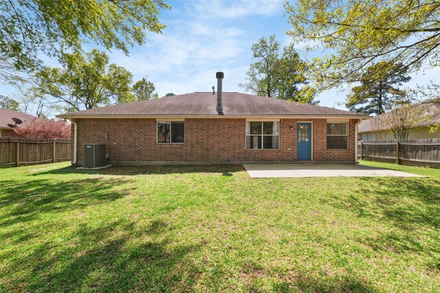 7014 Woodland Oaks, Magnolia, TX 77354 - rear view of property featuring a patio, brick siding, central AC, and roof with shingles