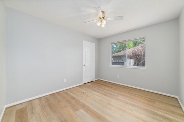 7014 Woodland Oaks, Magnolia, TX 77354 - empty room with baseboards, wood finished floors, and ceiling fan