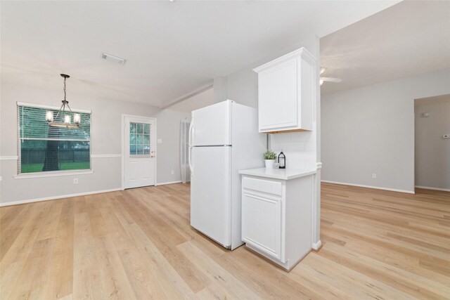 7014 Woodland Oaks, Magnolia, TX 77354 - kitchen with freestanding refrigerator, light wood-style floors, white cabinets, and light countertops
