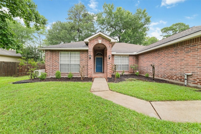 7014 Woodland Oaks, Magnolia, TX 77354 - view of front facade featuring brick siding and roof with shingles
