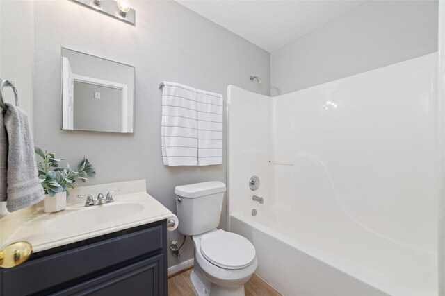 7014 Woodland Oaks, Magnolia, TX 77354 - bathroom featuring toilet, wood finished floors, vanity, shower / washtub combination, and baseboards