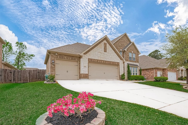 traditional-style house with fence, a front lawn, brick siding, a garage, and concrete driveway
