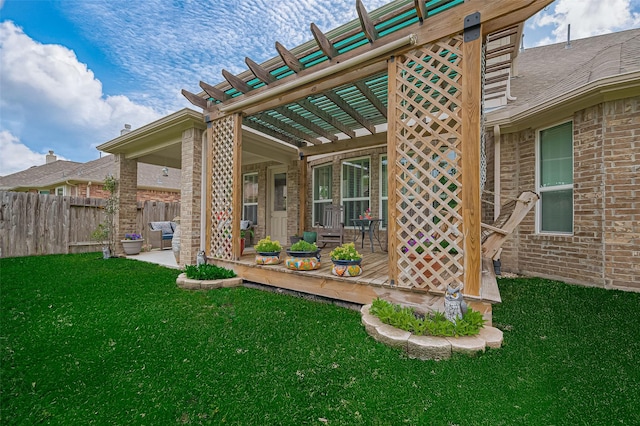 exterior space with a yard, a pergola, fence, and brick siding