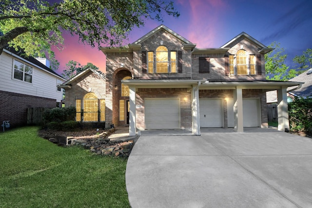 view of front of house with a lawn, driveway, and a garage
