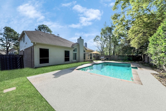 view of pool with a fenced backyard, a fenced in pool, a yard, and a patio area