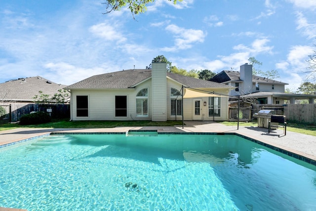view of swimming pool with a fenced backyard, a fenced in pool, and a patio