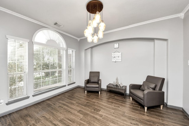 living area featuring dark wood-style flooring, visible vents, a chandelier, crown molding, and baseboards