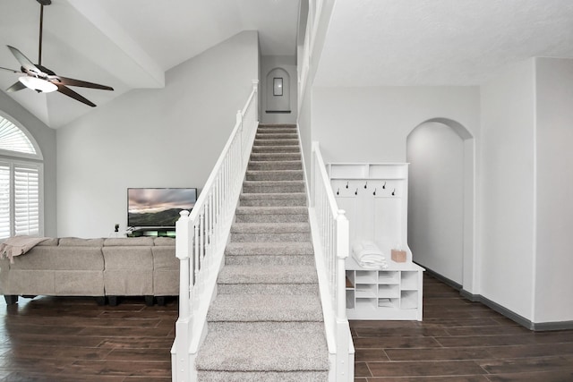 staircase featuring a ceiling fan, baseboards, lofted ceiling, and wood tiled floor