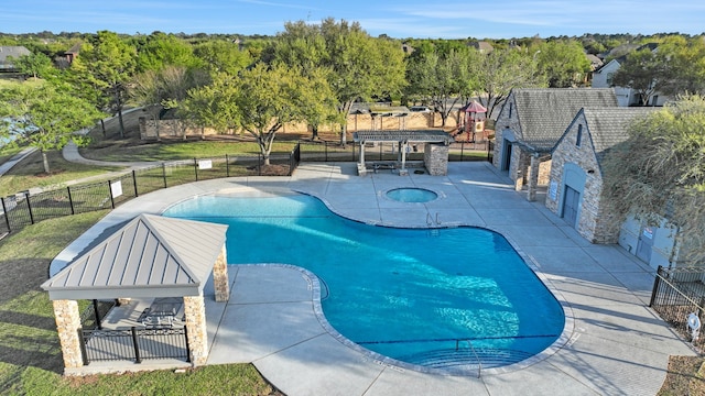 community pool with a gazebo, fence, and a patio area
