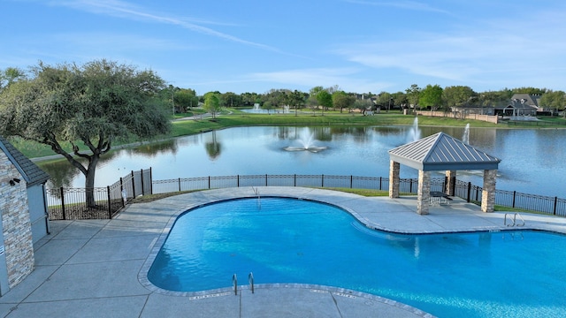 view of swimming pool with a water view, a gazebo, and fence