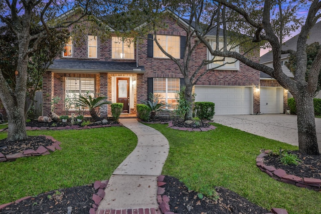 traditional home with brick siding, a front yard, and concrete driveway