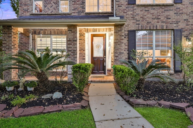 doorway to property featuring brick siding